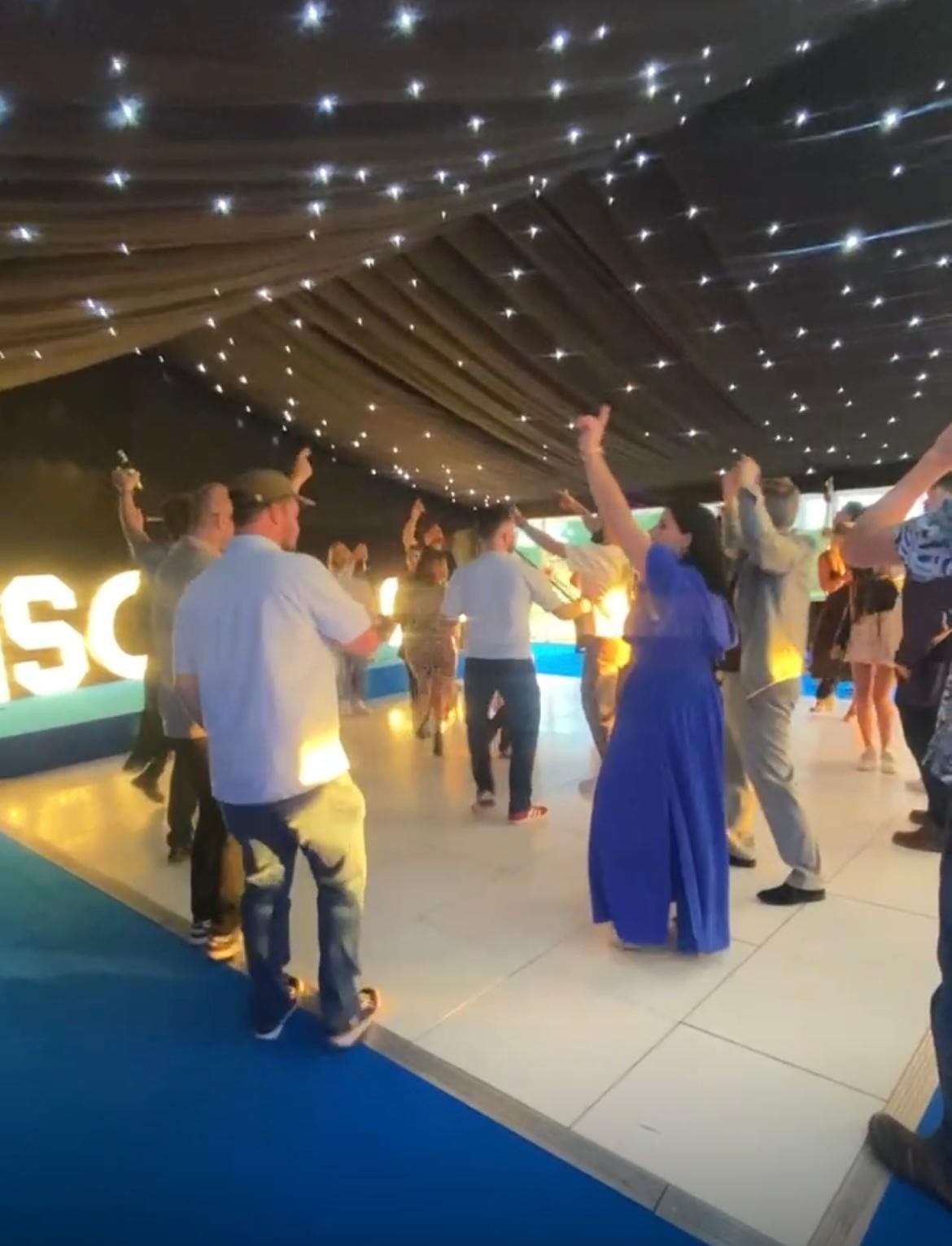 Guests dancing under the marquee's starlight ceiling